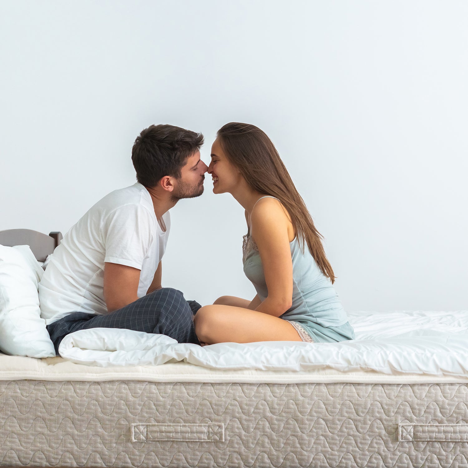 Man and Woman couple about to kiss while sitting on a Lytton Mattress